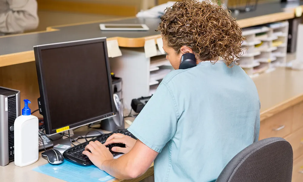 Receptionist making a phone call using Think Healthcare