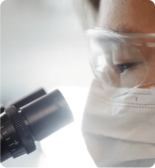 Female scientist using microscope